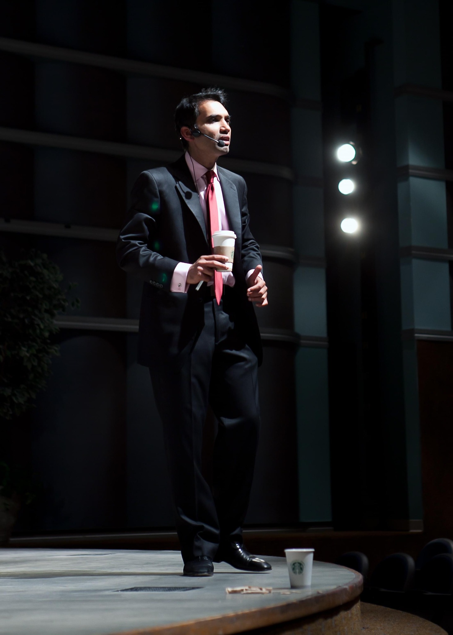 Srini Saripalli speaking on stage