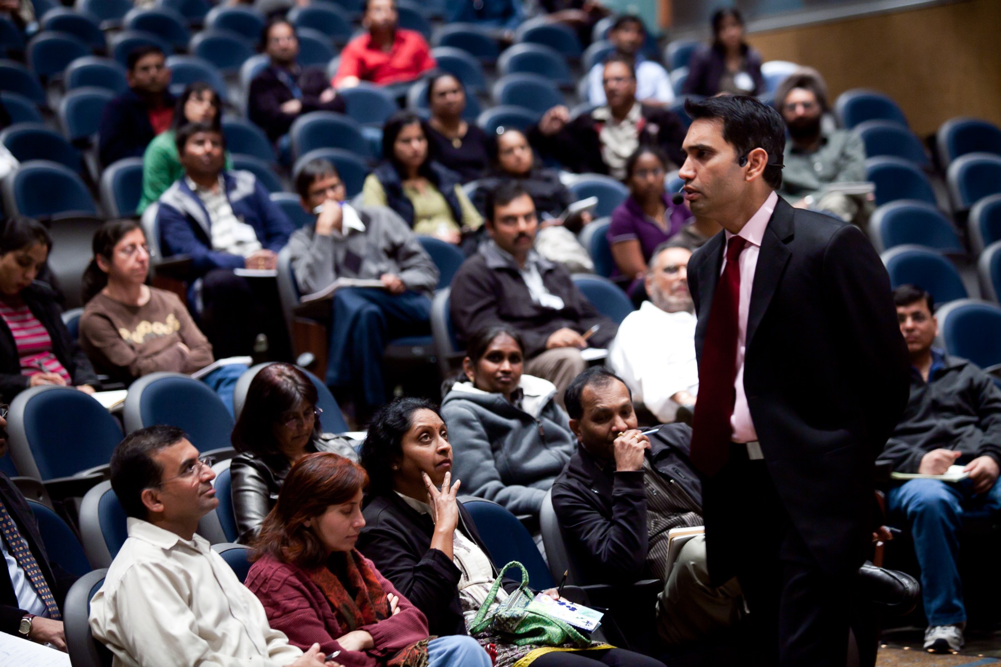 Srini Saripalli speaking among an audience